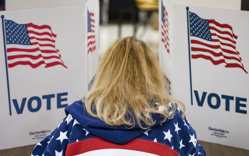 A voter fills in her ballots for the Democratic presidential primary election at a polling place in Armstrong Elementary School on Super Tuesday, in Virginia
