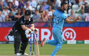 England's Mark Wood (R) celebrates after bowling New Zealand's James Neesham