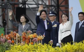 New Taiwan's President Lai Ching-te, center, Vice President Hsiao Bi-khim, right, and former President Tsai Ing-wen wave during Lai's inauguration ceremonies in Taipei, Taiwan, Monday, May 20, 2024. (AP Photo/Chiang Ying-ying)