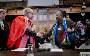 South African professor of International Law John Dugard and South African Minister of International Relations and Cooperation Naledi Pandor (R) arrive at the International Court of Justice (ICJ) prior to the verdict announcement in the genocide case against Israel, brought by South Africa, in The Hague on January 26, 2024. The top UN court said Israel should do everything it could to prevent any acts of genocide in the Gaza Strip, in a highly anticipated ruling. Israel must do everything to "prevent the commission of all acts within the scope" of the Genocide Convention, said the International Court of Justice on January 26, 2024. (Photo by Remko de Waal / ANP / AFP) /