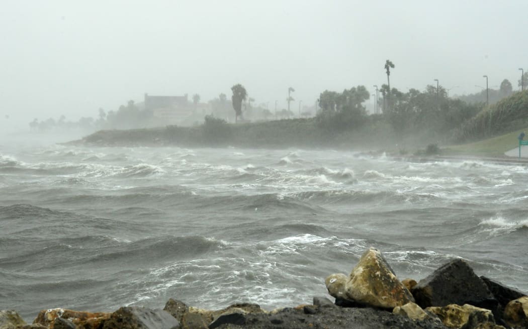 Strong winds batter seaside houses before the approaching Hurricane Harvey in Corpus Christi, Texas.