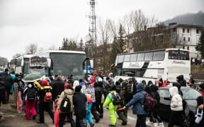 People board buses after a day in the small ski resort of Roccaraso, on February 2, 2025. Local authorities limited the numbers after more than 200 buses with approximately 10,000 tourists turned up last weekend after a call by Neopolitan tiktok star Rita De Crescenzo to join her in the small town in the central Abruzzo region, causing huge traffic jams and chaos.