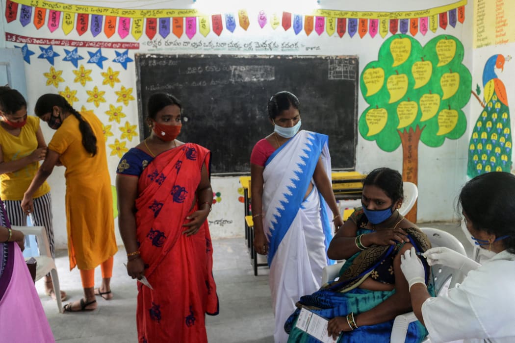 A health worker delivers a Covaxin dose at a school on the outskirts of Hyderabad in July 2021.