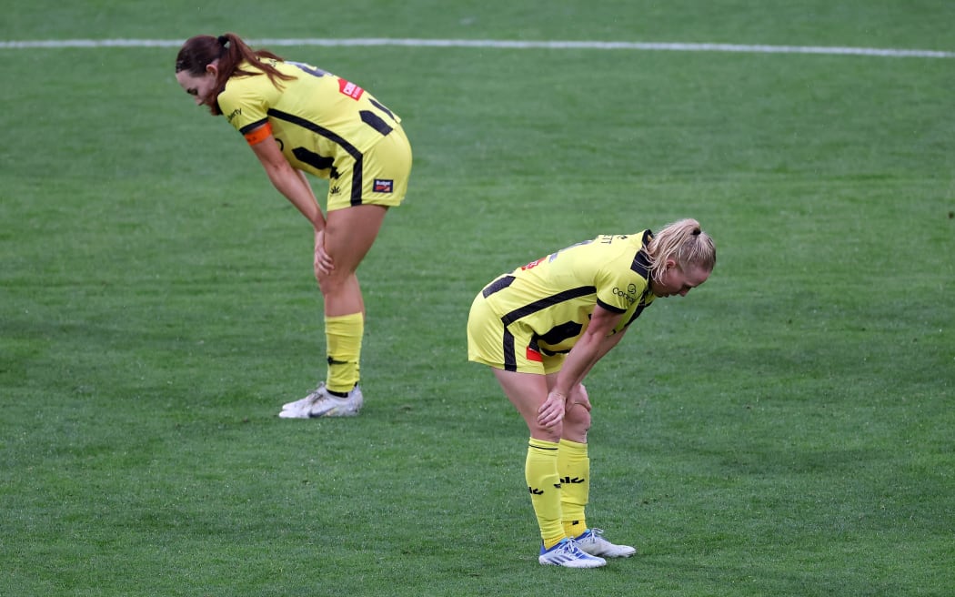 Phoenix pair Mackenzie Barry (L) with Betsy Hassett stand dejected after their women's A-League loss to Adelaide United.
