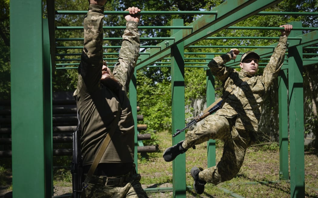 Newly recruited soldiers of the 3rd assault brigade train in Kyiv, Ukraine, Friday, May 17, 2024. A divisive mobilisation law in Ukraine came into force on Saturday, as Kyiv struggles to boost troop numbers after Russia launched a new offensive.