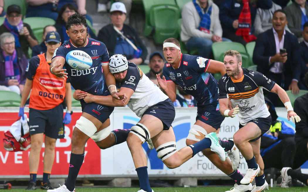 Rob Leota of the Rebels passes the ball.
