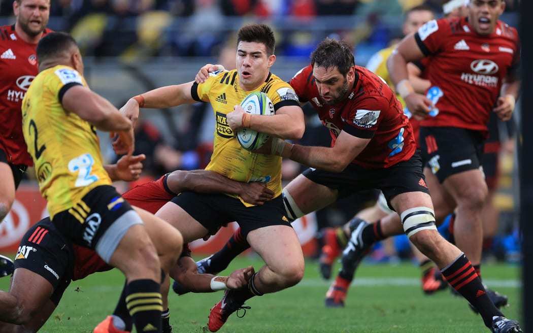 Hurricanes' Jackson Garden-Bachop is tackled by Crusaders Samuel Whitelock.