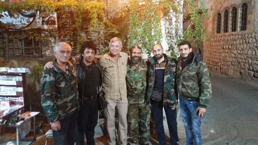 Warren Marriner poses with Syrian National Defence Force troops in Damascus.