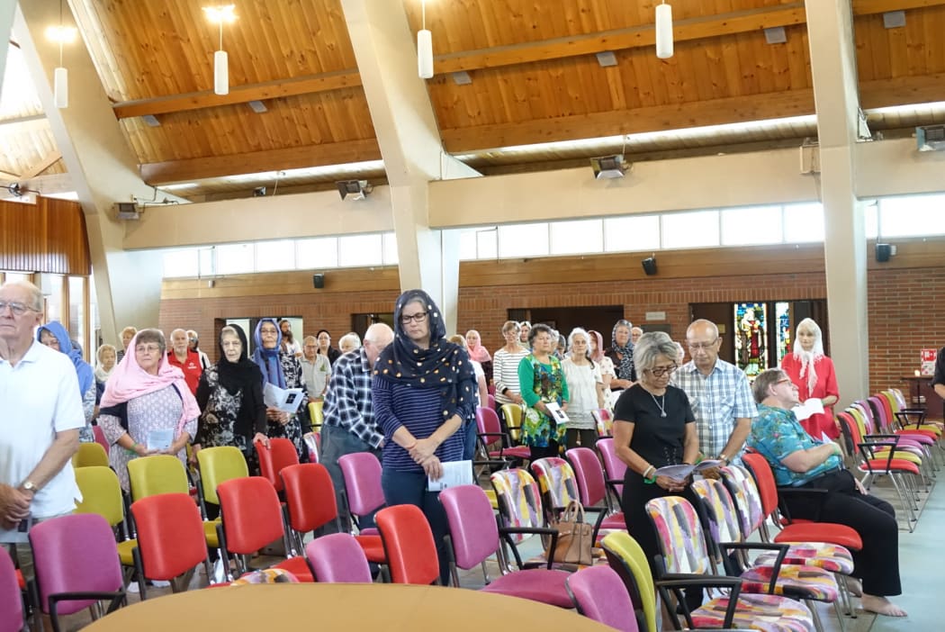 Whangarei Anglicans face Mecca, wearing scarves, and after leaving their shoes at the church door today to show support for Muslims.