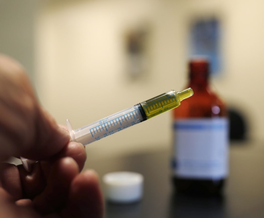 A syringe loaded with a dose of CBD oil  in a research laboratory at Colorado State University