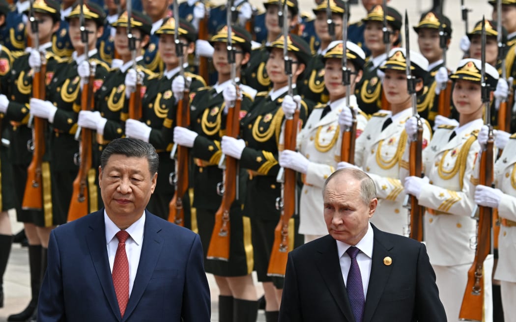 In this pool photograph distributed by the Russian state agency Sputnik, Russia's President Vladimir Putin and China's President Xi Jinping attend an official welcoming ceremony in front of the Great Hall of the People in Tiananmen Square in Beijing on May 16, 2024. (Photo by Sergei BOBYLYOV / POOL / AFP) / ** Editor's note : this image is distributed by Russian state owned agency Sputnik **