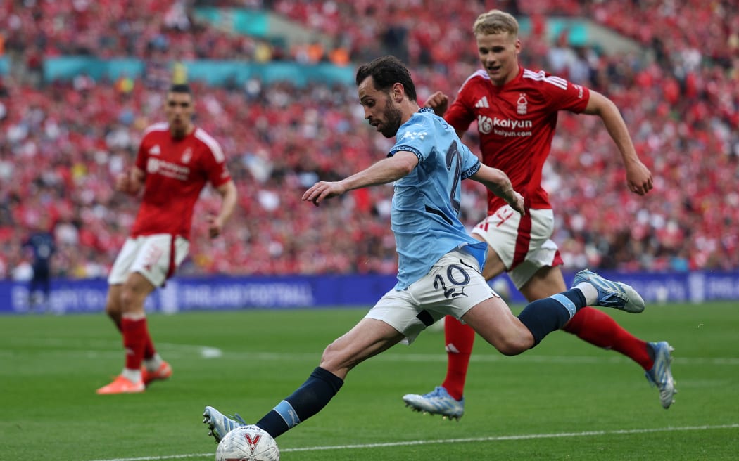 Manchester City's Portuguese midfielder #20 Bernardo Silva crosses the ball during the English FA Cup semi-final football match between Nottingham Forest and Manchester City at Wembley Stadium in north London on April 27, 2025. (Photo by Adrian Dennis / AFP) / NOT FOR MARKETING OR ADVERTISING USE / RESTRICTED TO EDITORIAL USE