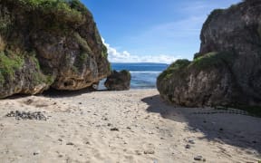 A beach in Tinian, CNMI, used for subsistence fishing and recreation by local residents.  Proposed US military live-fire training would prevent access to this beach much of the year. Saipan is visible just across the water.