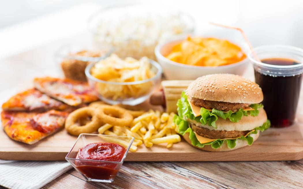 Close up of fast food snacks and drink on table.