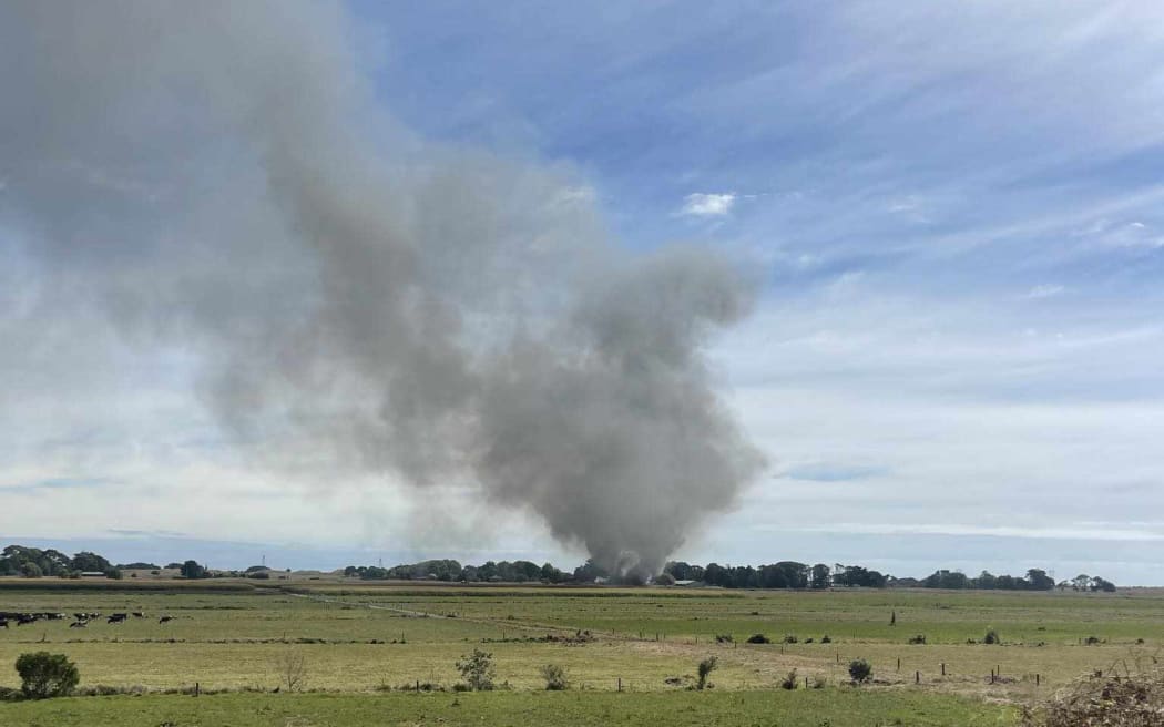 Photo showing smoke from a workshop fire near Te Horo Beach, on Swamp Rd at the chicken farm (storage shed not housing chickens).