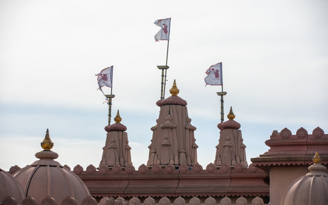 Flags flying on the roof of the Swaminarayan temple in Papatoetoe