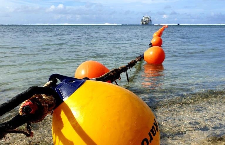 The first cable buoy reaching land in Rutaki, Rarotonga, Cook Islands.