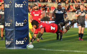 Jordan Taufua of the Crusaders dives over to score a try. against the ACT Brumbies.
