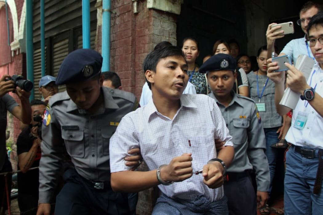 Detained Myanmar journalist Kyaw Soe Oo is escorted by police to a court.