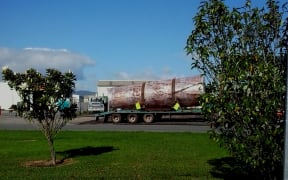 A kauri log "carving" wrapped in plastic, leaving a warehouse in Awanui for export.