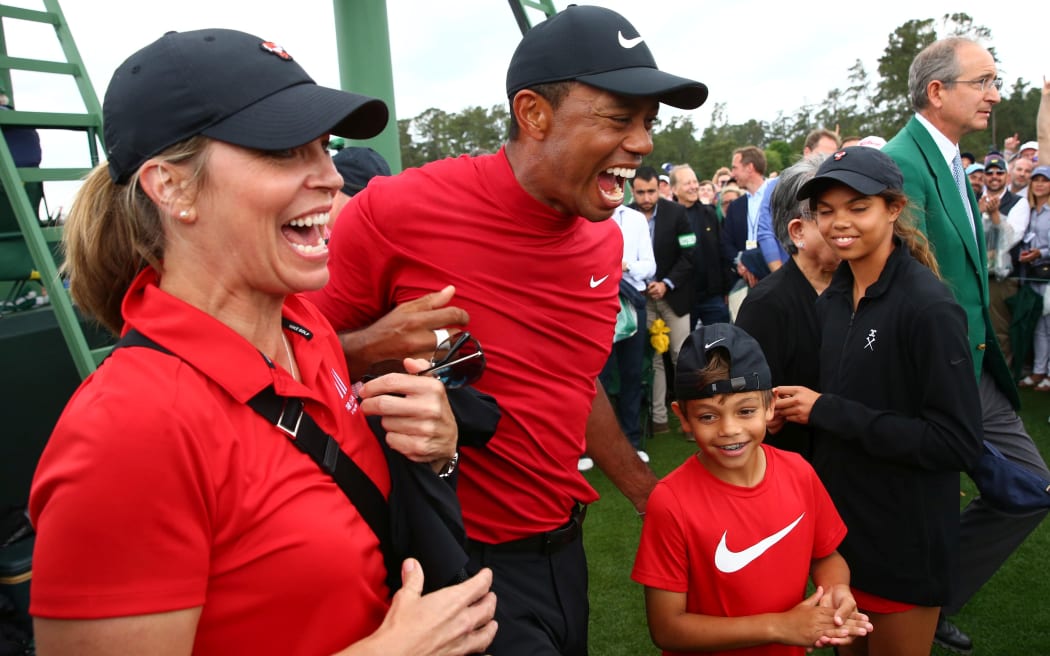 Tiger Woods celebrates with daughter Sam and son Charlie after winning The Masters golf tournament at Augusta National Golf Club.