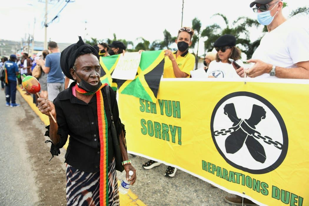 People calling for slavery reparations, protest outside the entrance of the British High Commission during the visit of the Duke and Duchess of Cambridge in Kingston, Jamaica on March 22, 2022.