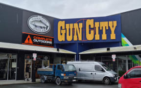 A repair crew's truck is outside Gun City on Cranford Street, Christchurch on 2 December 2022, following a ram raid on the store.