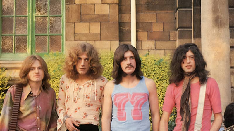 A 60s photo of the band Led Zeppelin with long hair and colourful clothes at Bath Festival, 1969