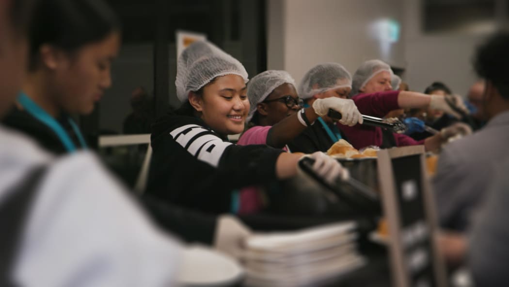 Members of the Life Church soup kitchen group serve dinner in South Auckland