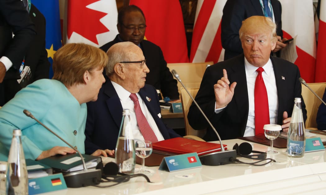 German Chancellor Angela Merkel, 
Tunisia's President Beji Caid Essebsi and Donald Trump at the G7 Summit expanded session, on May 27, 2017 in Taormina, Sicily.