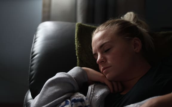 Young woman napping in an armchair