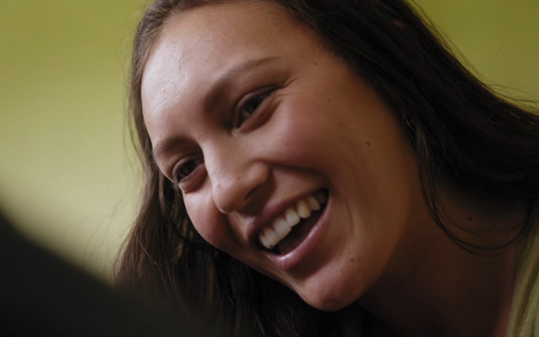 Pianika smiling down at baby