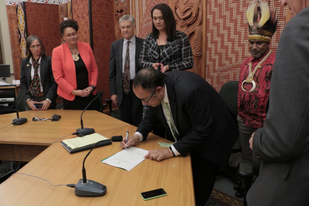New Zealand MPs sign the International Parliamentarians for West Papua declaration as Benny Wenda the head of the West Papua Freedom Movement looks on. Wellington 10-05-2017.