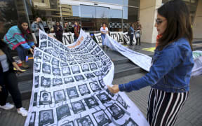 People demonstrate against the "false positives", executions of civilians at the hands of the military who presented them as combat casualties to swell results of the armed conflict.