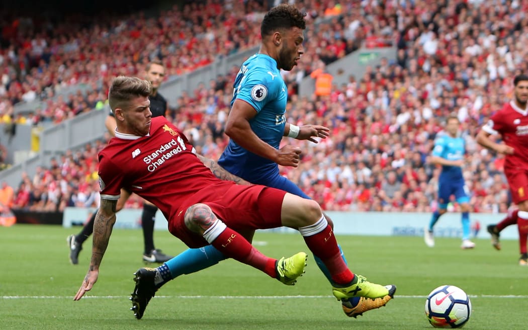 Alex Oxlade-Chamberlain in his final game for Arsenal, takes on new teamate  Alberto Moreno of Liverpool.