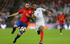 Nacho of Spain and Raheem Sterling of England battle for the ball.