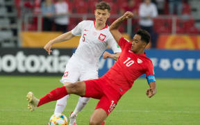 Tahiti's Roonui Tehau battles for possession with Poland's Serafin Szota during their FIFA U-20 World Cup group A match.
