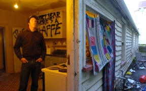 Third-year University of Otago student Sam Uffindell in the kitchen of his environmentally hazardous Dundas St flat. The drain visible outside the back door previously poured toilet waste into the back yard.