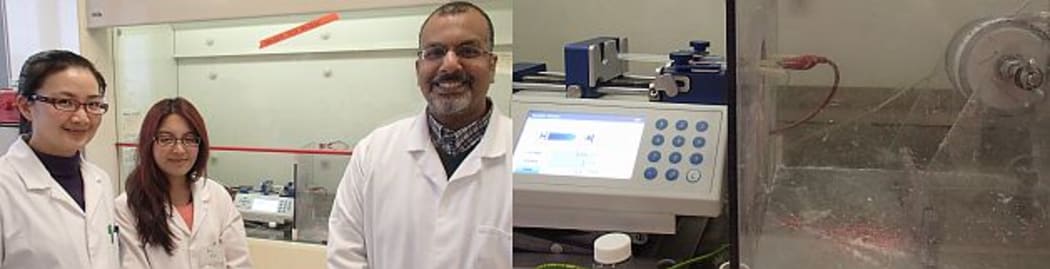 Food scientist Alaa El-Din Bekhit and summer students Avis Kao and Lei Xia, standing next to the electro-spinning machine that incorporates polyphenols with natural polymers to create textiles.