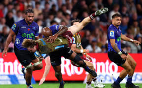 Mark Tele'a tackles Tim Ryan during the Reds v Blues Super Rugby Pacific match.