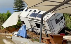 This screen grab made from UGC footage courtesy of Facebook user Dion Siluch taken and released on January 22, 2026 shows the aftermath of a landslide at Mount Hot Pools in Mount Maunganui. A landslide smashed into a campsite in rain-swept northern New Zealand on January 22 leaving multiple people missing, police and rescuers said. (Photo by Handout / Courtesy of Facebook user Dion Siluch / AFP) / RESTRICTED TO EDITORIAL USE - MANDATORY CREDIT "AFP PHOTO /  COURTESY OF FACEBOOK USER DION SILUCH" - HANDOUT - NO MARKETING NO ADVERTISING CAMPAIGNS - DISTRIBUTED AS A SERVICE TO CLIENTS