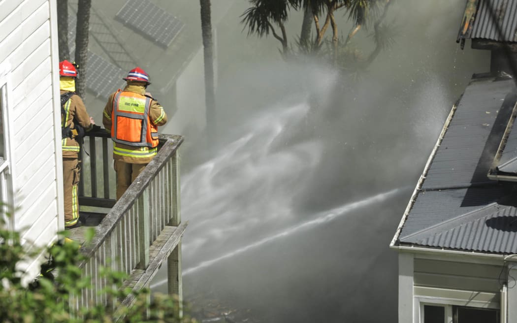 Firefighters attend the scene of a house fire in Kelburn.