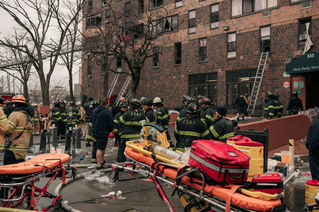 Emergency first responders remain at the scene of an intense fire at a 19-story residential building.