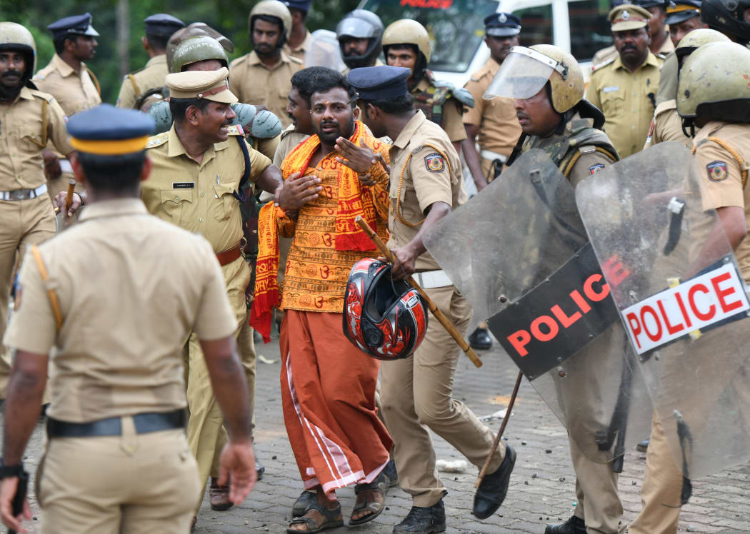 Indian police take a Hindu activist into custody as protesters rallied against a Supreme Court verdict revoking a ban on women's entry to a Hindu temple, in Nilackal in southern Kerala state.