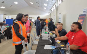 Minister for Pacific Peoples Barbara Edmonds (in high-viz vest) talks to people at the Mangere Community Hub.