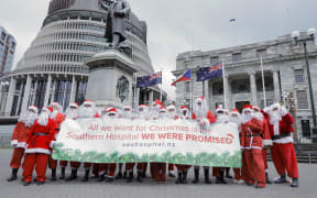 A group of 20 santas gathered at Parliament as part of the 'Save our Southern Hospital' campaign for the government to deliver a tertiary care level hospital to Dunedin.