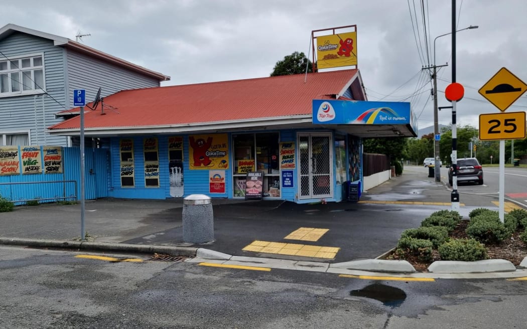 Flowers outside the Opawa Discounter, where the business' owner was stabbed during a robbery on 2 December. Christchurch