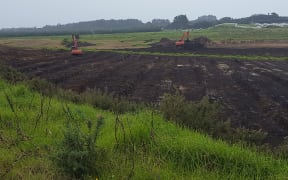 Diggers moving earth at Motutangi for new avocado orchards.