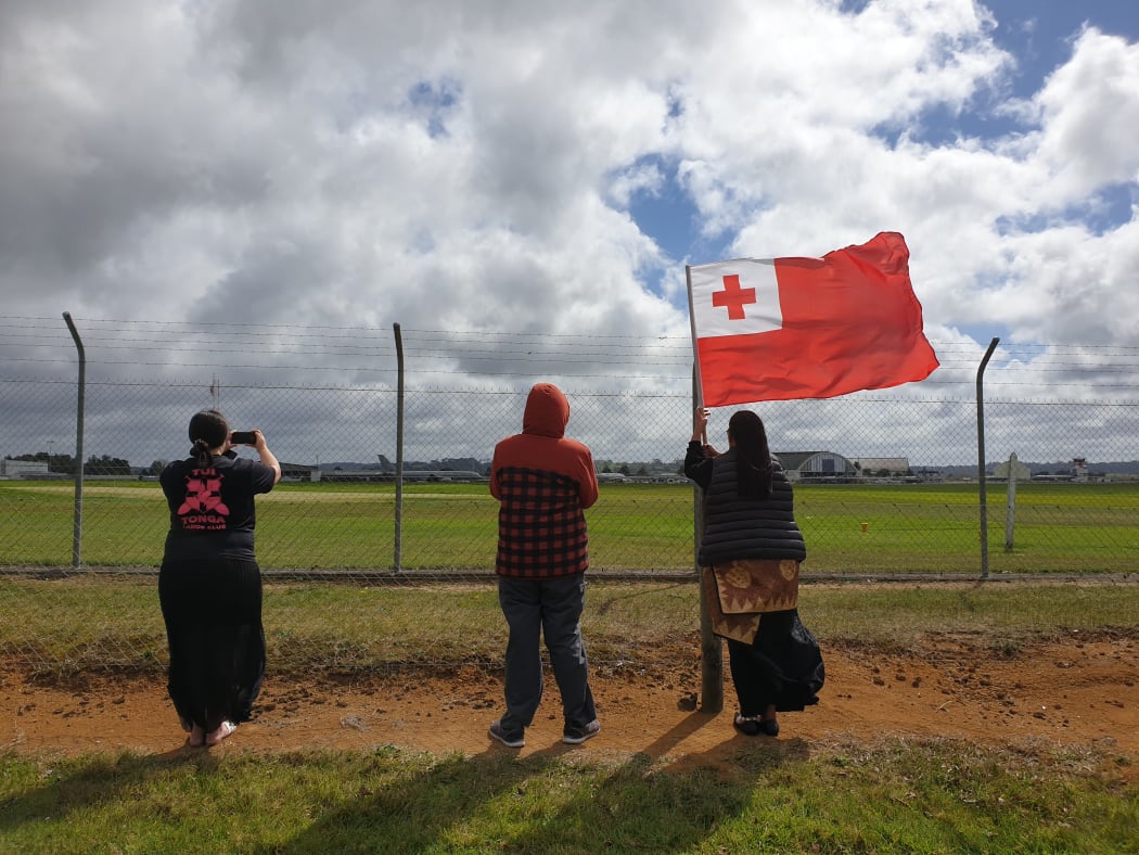 About 10 people gathered outside the base to watch as the plane took off.