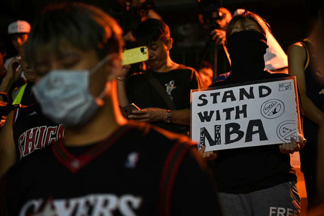 A protester holds a sign at the Southorn Playground in Hong Kong on October 15, 2019, during a rally in support of NBA basketball Rockets general manager Daryl Morey and against comments made by Lakers superstar LeBron James.